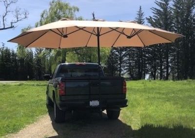 Humbra Mobile Shade Solution open and attached to back of pickup truck