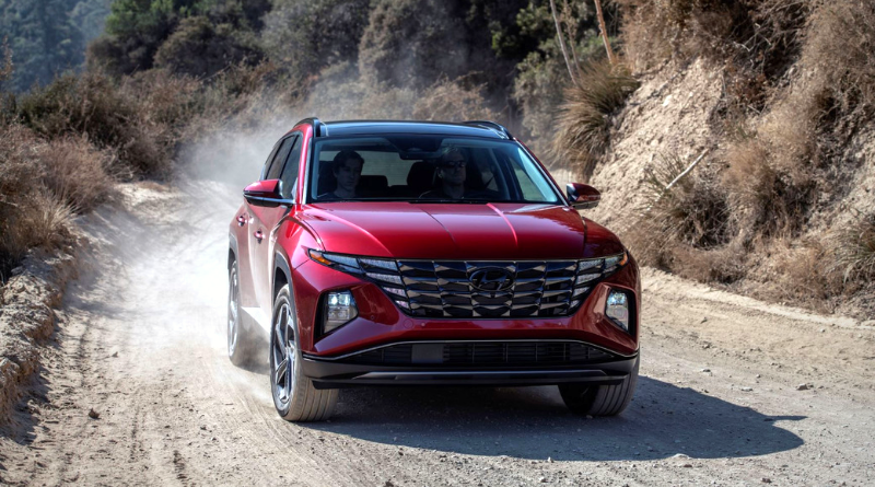 Red Hyundai Tucson zips down a dusty dirt road
